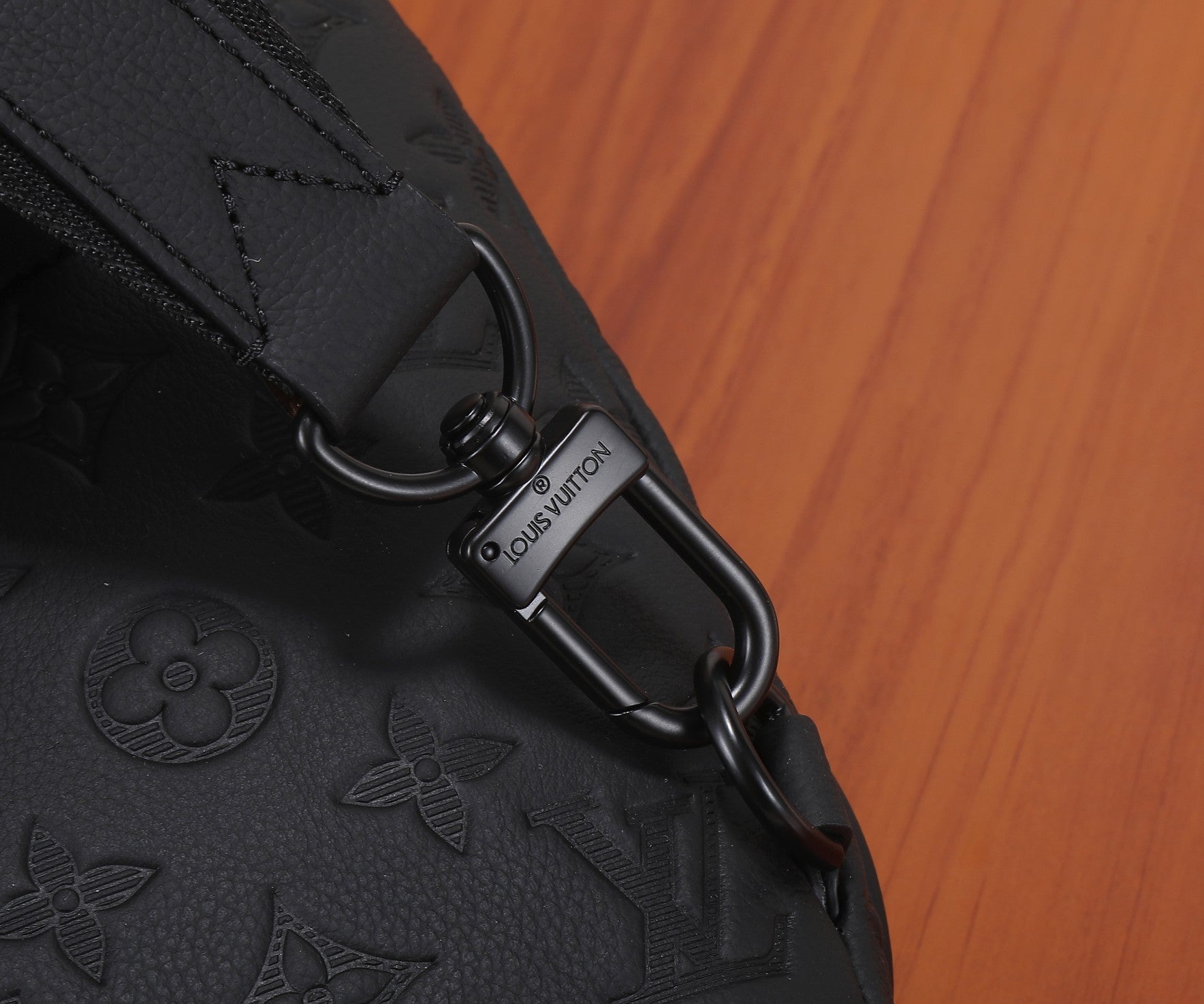 Louis Vuitton bag metal key ring detail engraved on black strap
