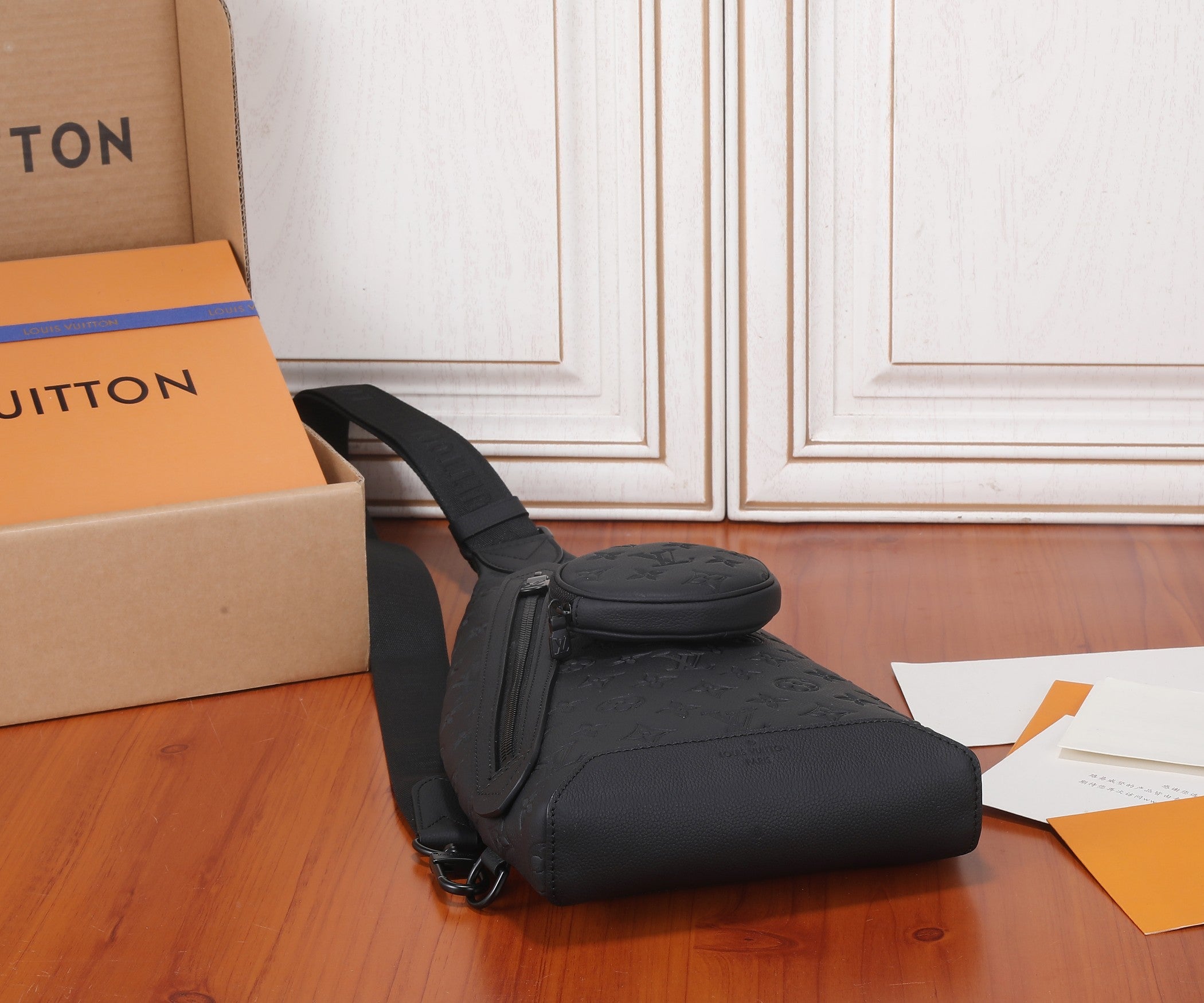 Louis Vuitton men's sling bag in black monogram leather with front flap and strap