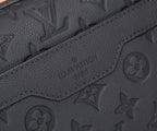 Black embossed monogram crossbody bag seam and logo stamp detail