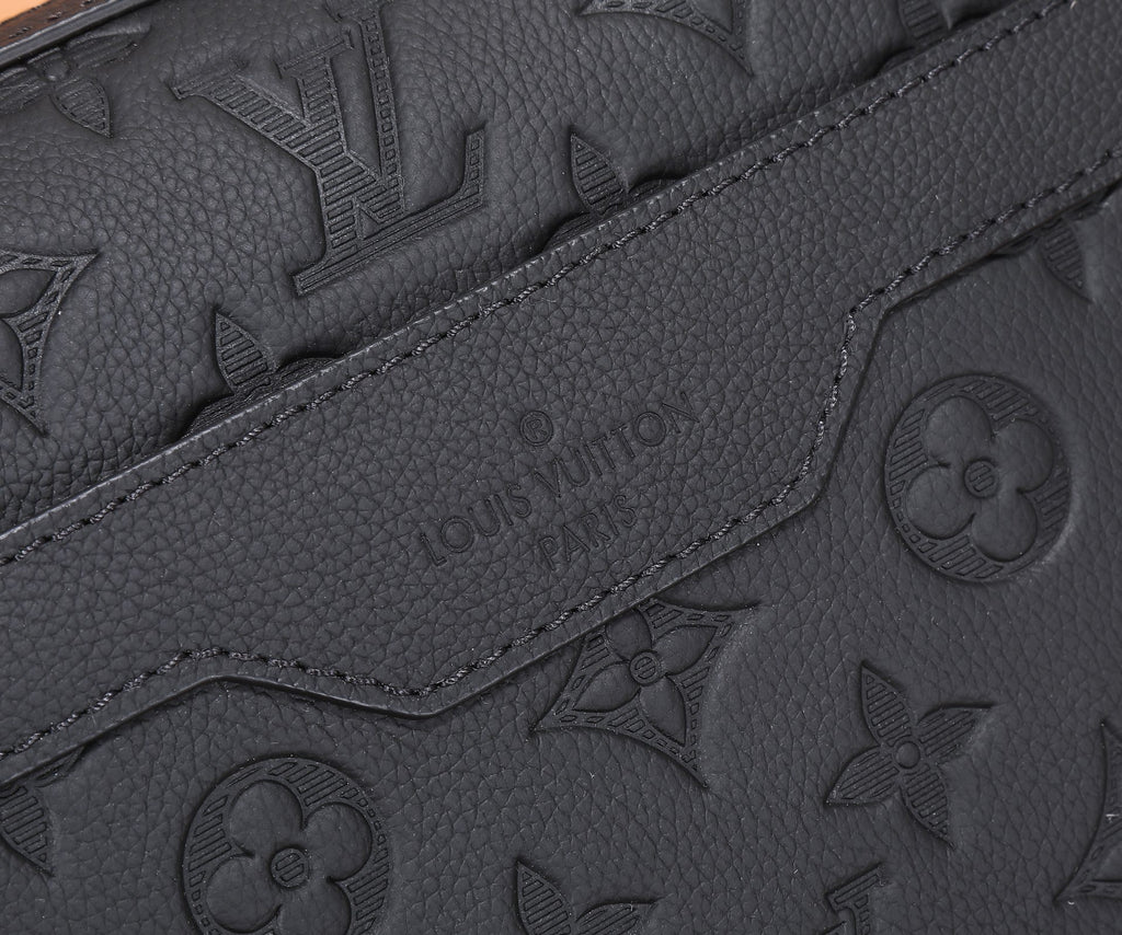 Black embossed monogram leather with embossed “Louis Vuitton” text and curved seam