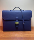 Hermes briefcase bag in textured blue leather with front flap and brass turn-lock