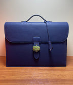 Hermes briefcase bag in textured blue leather with front flap and brass turn-lock