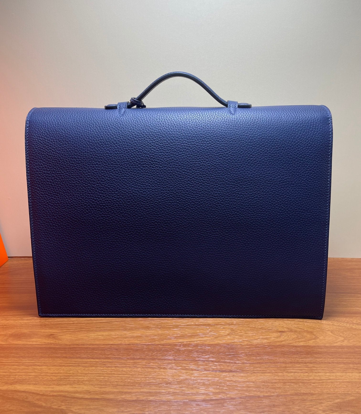 Hermes briefcase bag in textured blue leather with top handle, back view