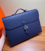 Hermes briefcase bag in textured blue leather with front flap and turn-lock close-up