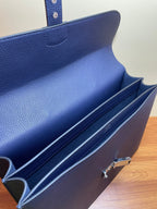 Hermes briefcase bag interior with flap open and dark lined compartments