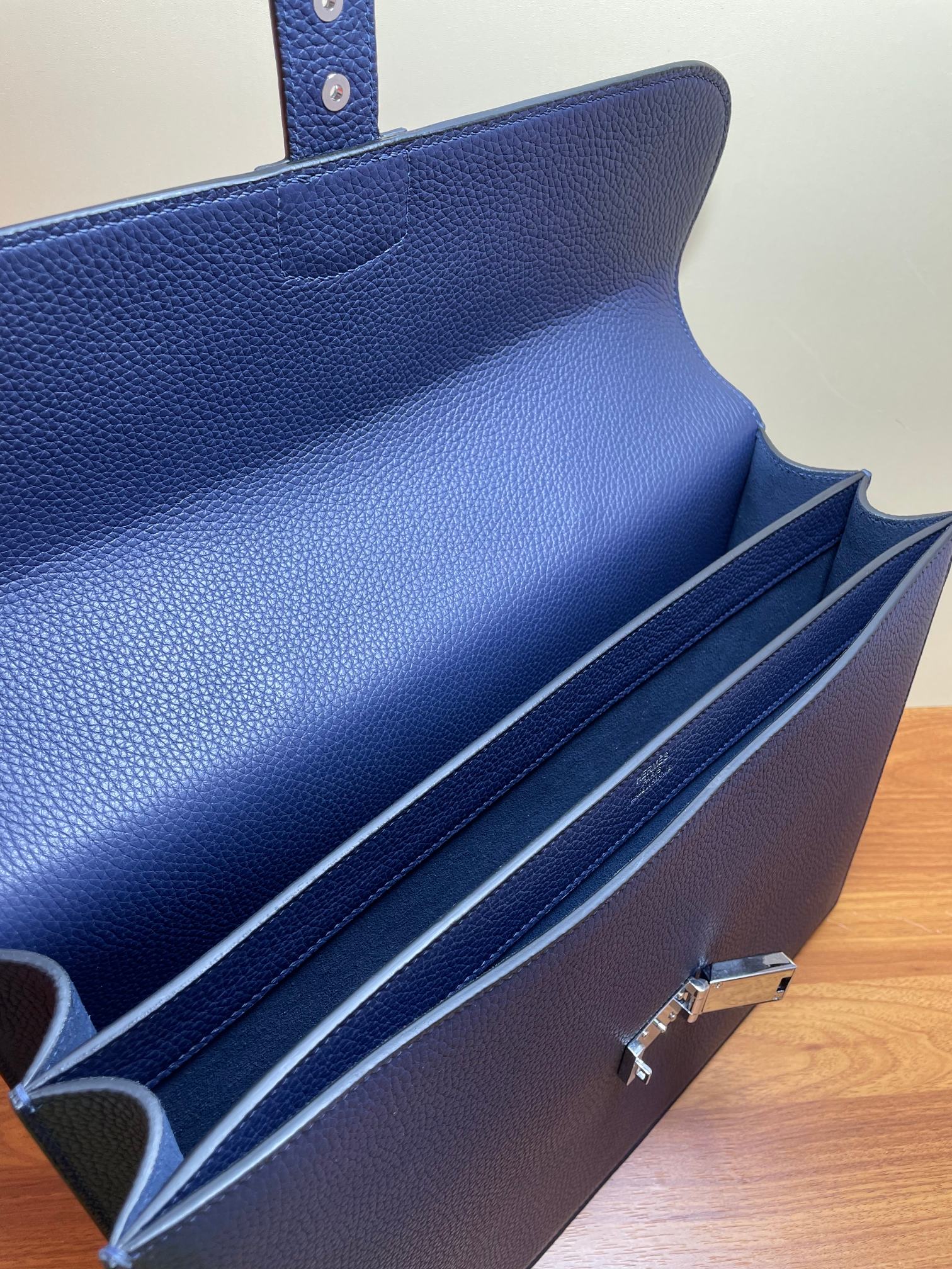 Hermes briefcase bag interior with flap open and dark lined compartments