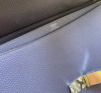 Hermes bag label and stitching on textured blue leather with brass hardware