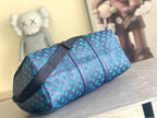 Teal monogram duffel bag with black strap and end view hardware