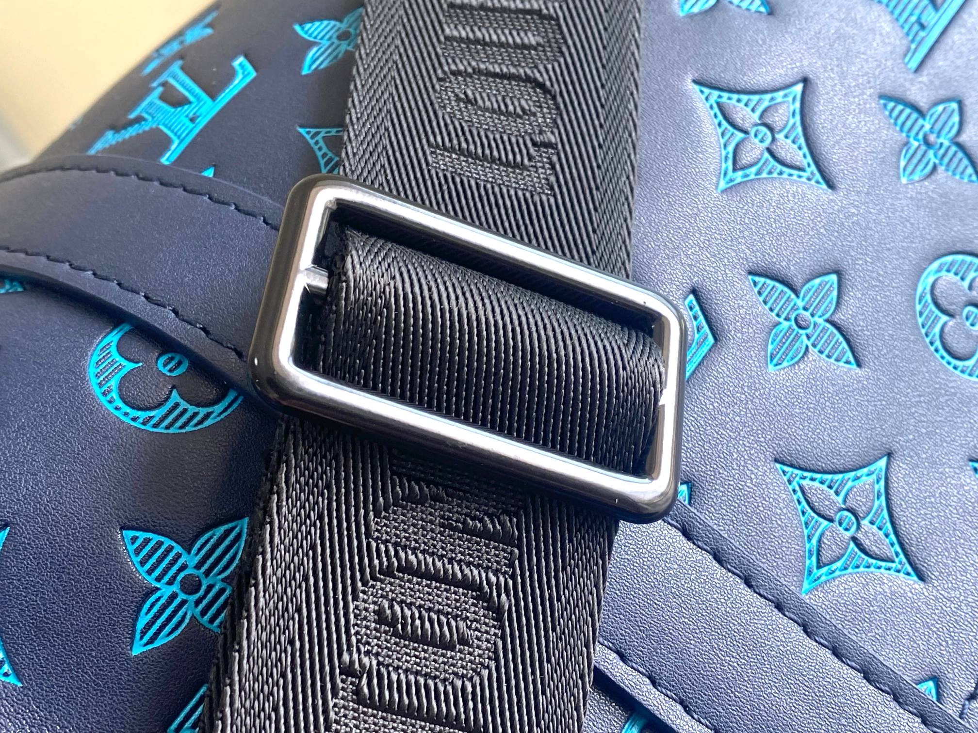 Louis Vuitton duffel bag leather strap with rectangular silver buckle and blue stitching