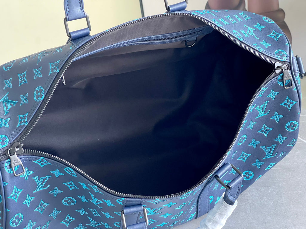 Teal monogram duffel bag interior with dark lining and open zipper mouth