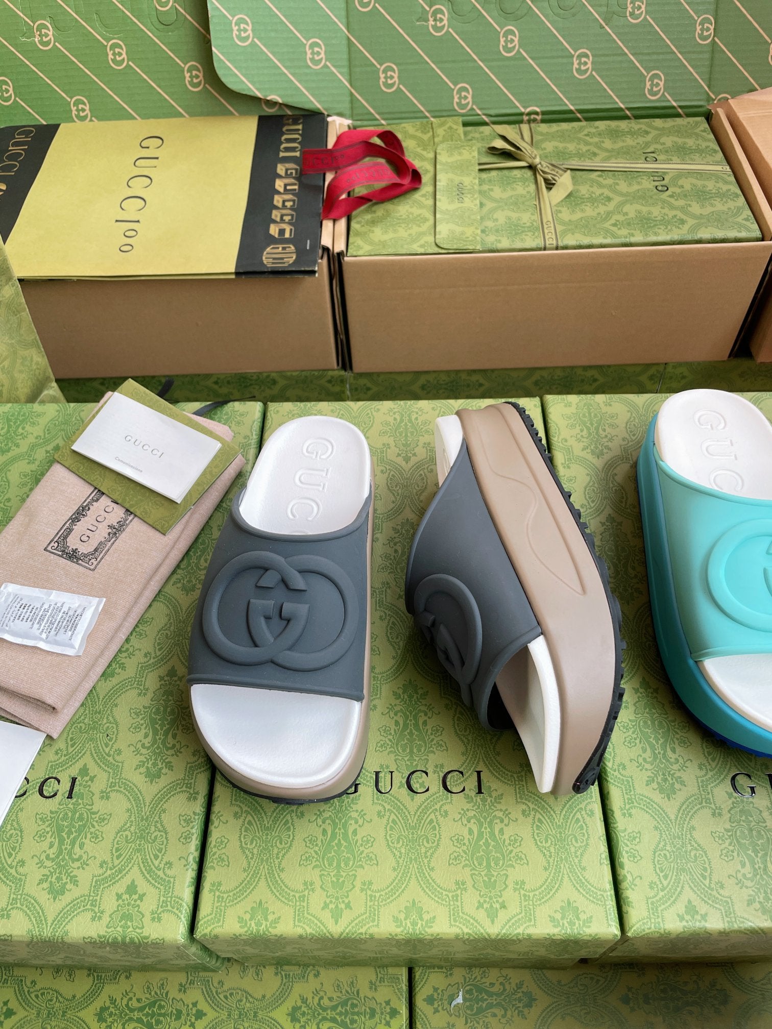 Gucci logo slide sandals, dark gray straps with white footbed and side view