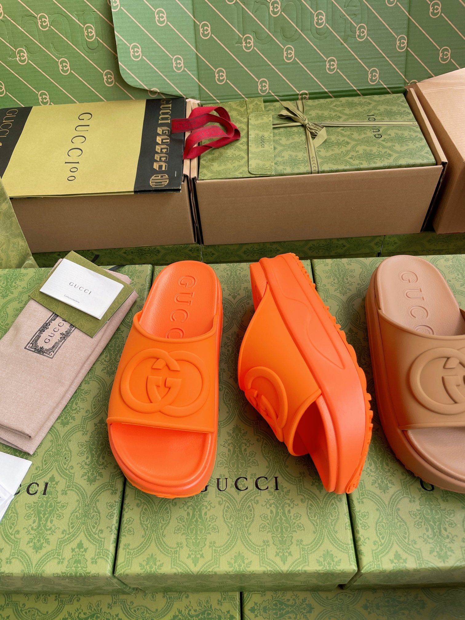 Gucci logo slide sandals, orange slides with embossed logo on footbed