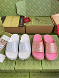 Logo slide sandals, white and pink with embossed interlocking emblem on straps