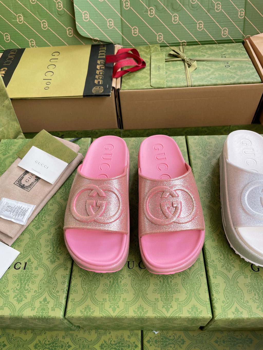 Pink logo slide sandals with embossed interlocking emblem on wide straps
