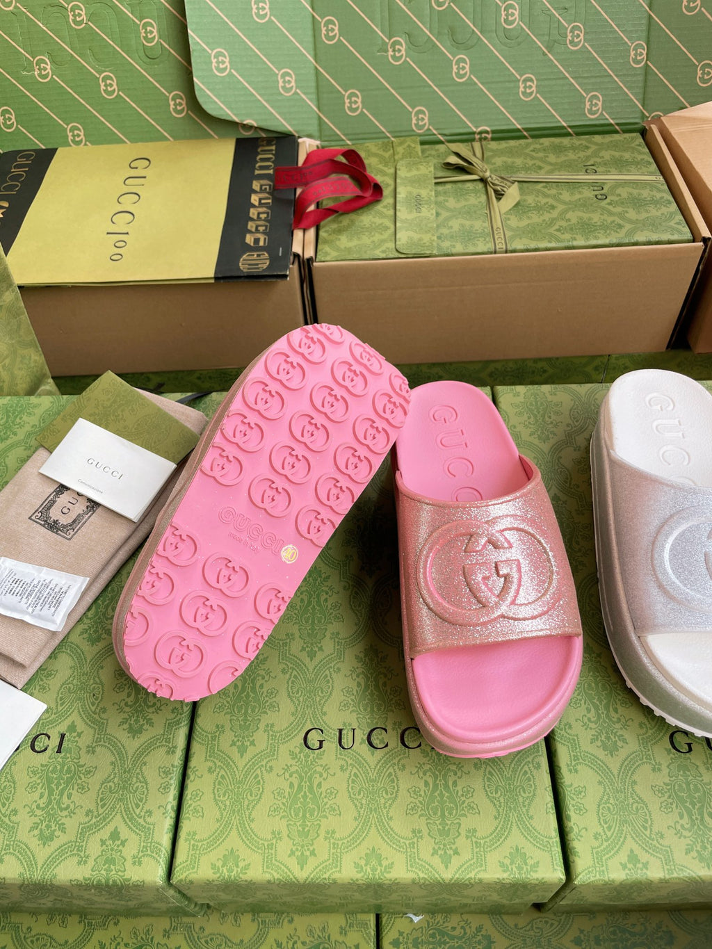 Pink logo slide sandals with embossed footbed and emblem on wide strap