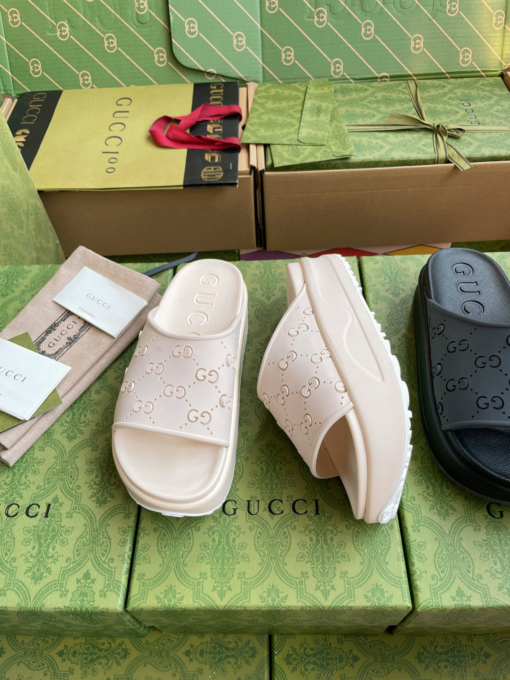 White GG logo slide sandals with embossed straps and thick sole