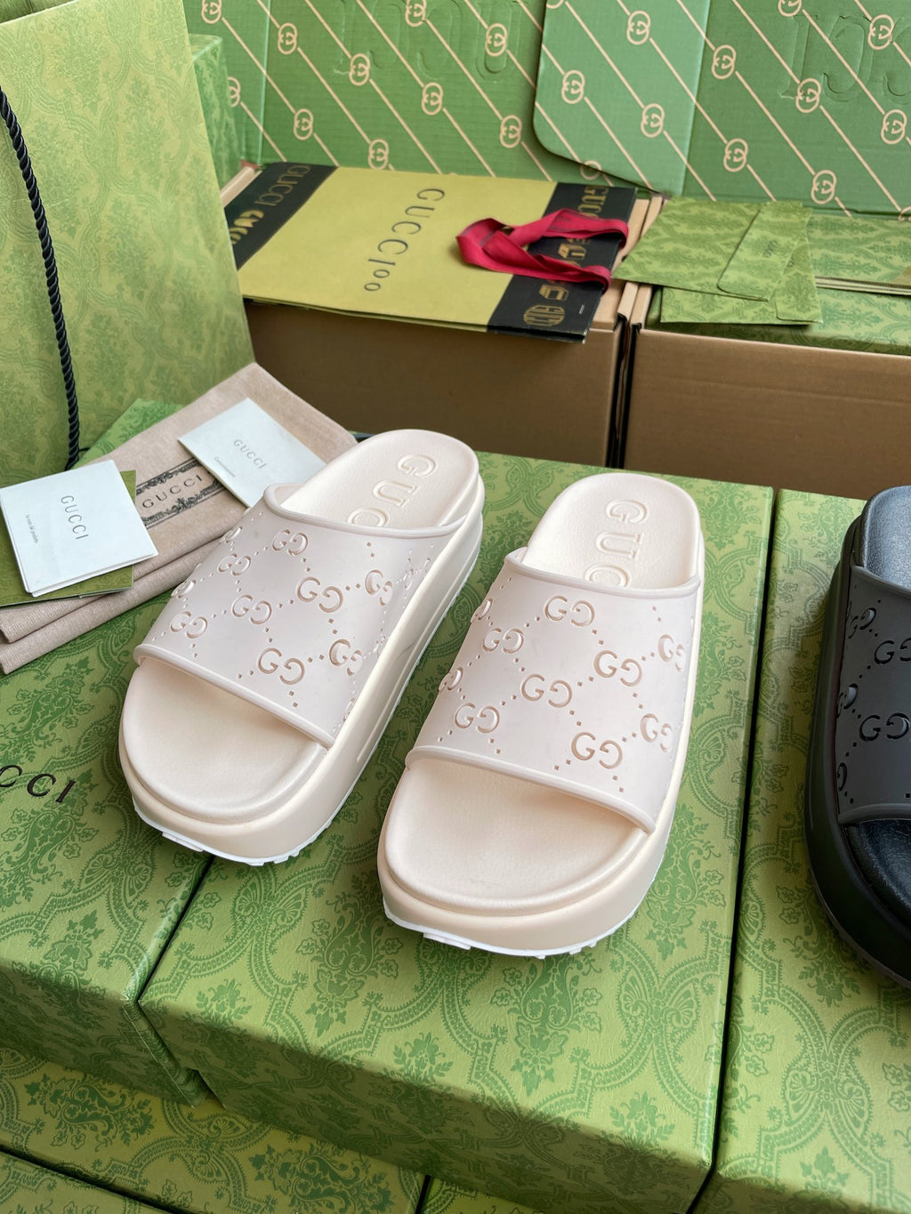 White GG logo slide sandals, embossed allover pattern on straps and footbed
