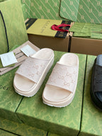 White GG logo slide sandals, embossed allover pattern on straps and footbed