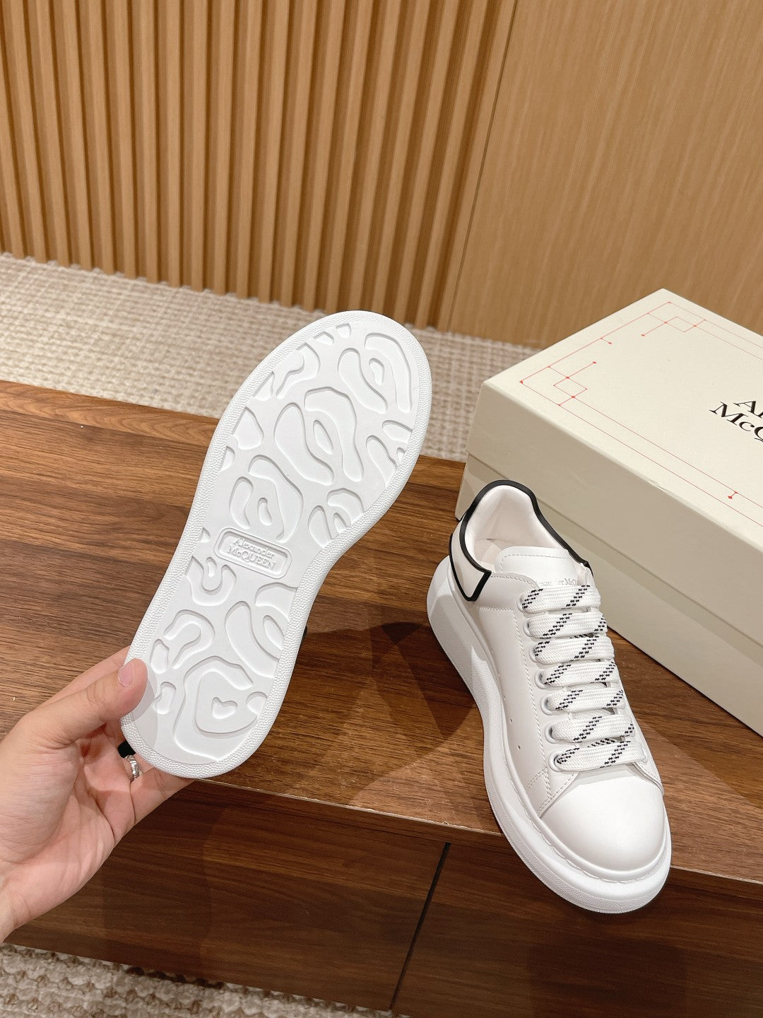 White sneaker outsole with tread detail and white Alexander McQueen lace-up upper