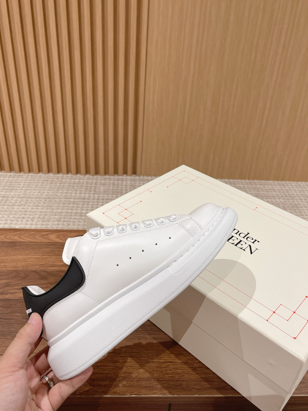 Alexander McQueen white leather sneakers with black heel detail and lace-up front