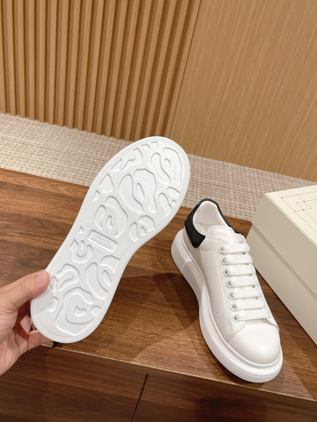 Alexander McQueen white sneakers with black heel trim, outsole view