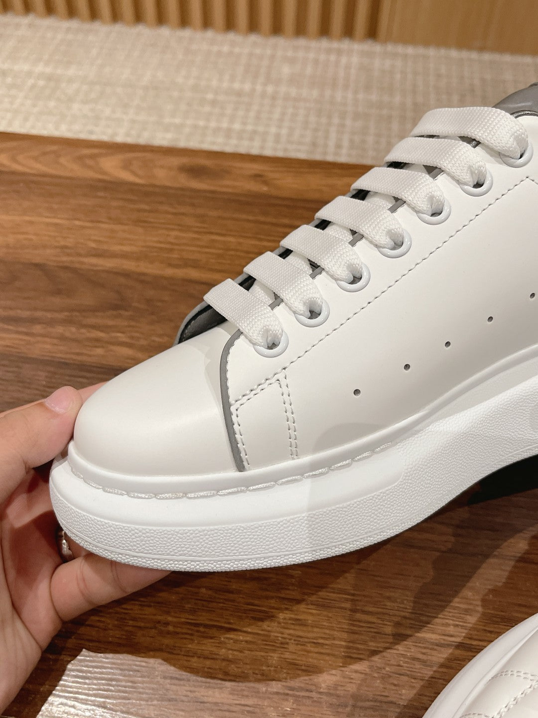 White Alexander McQueen low-top sneakers with white laces and textured toe cap