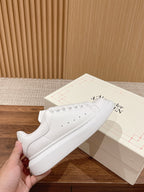 Alexander McQueen white lace-up sneakers with perforated toe and smooth leather upper