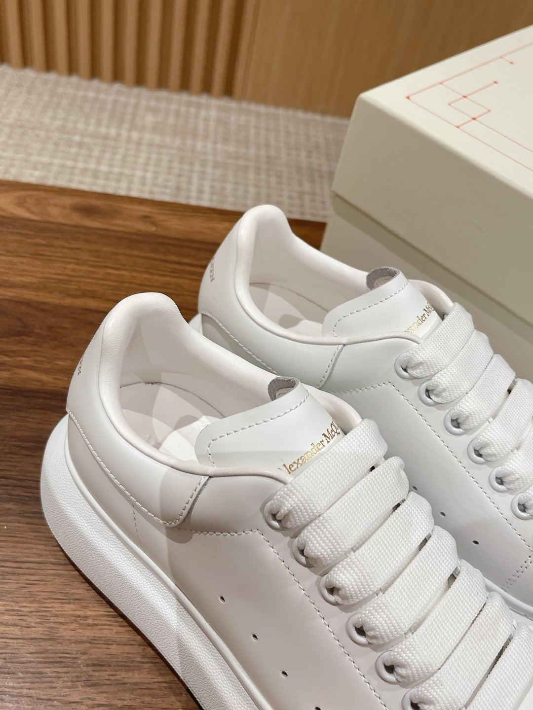 Alexander McQueen white lace-up sneakers, top view showing laces and toe cap
