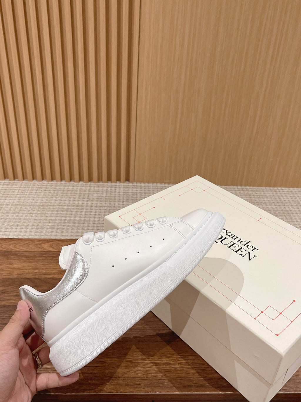 White lace-up sneakers with perforated details and smooth toe