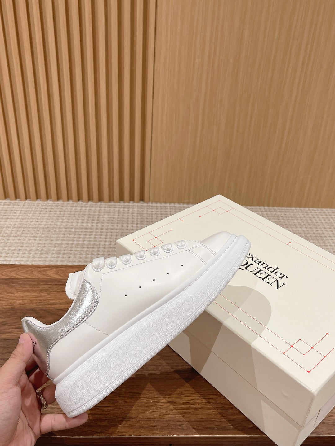 White lace-up sneakers with perforated details and smooth toe