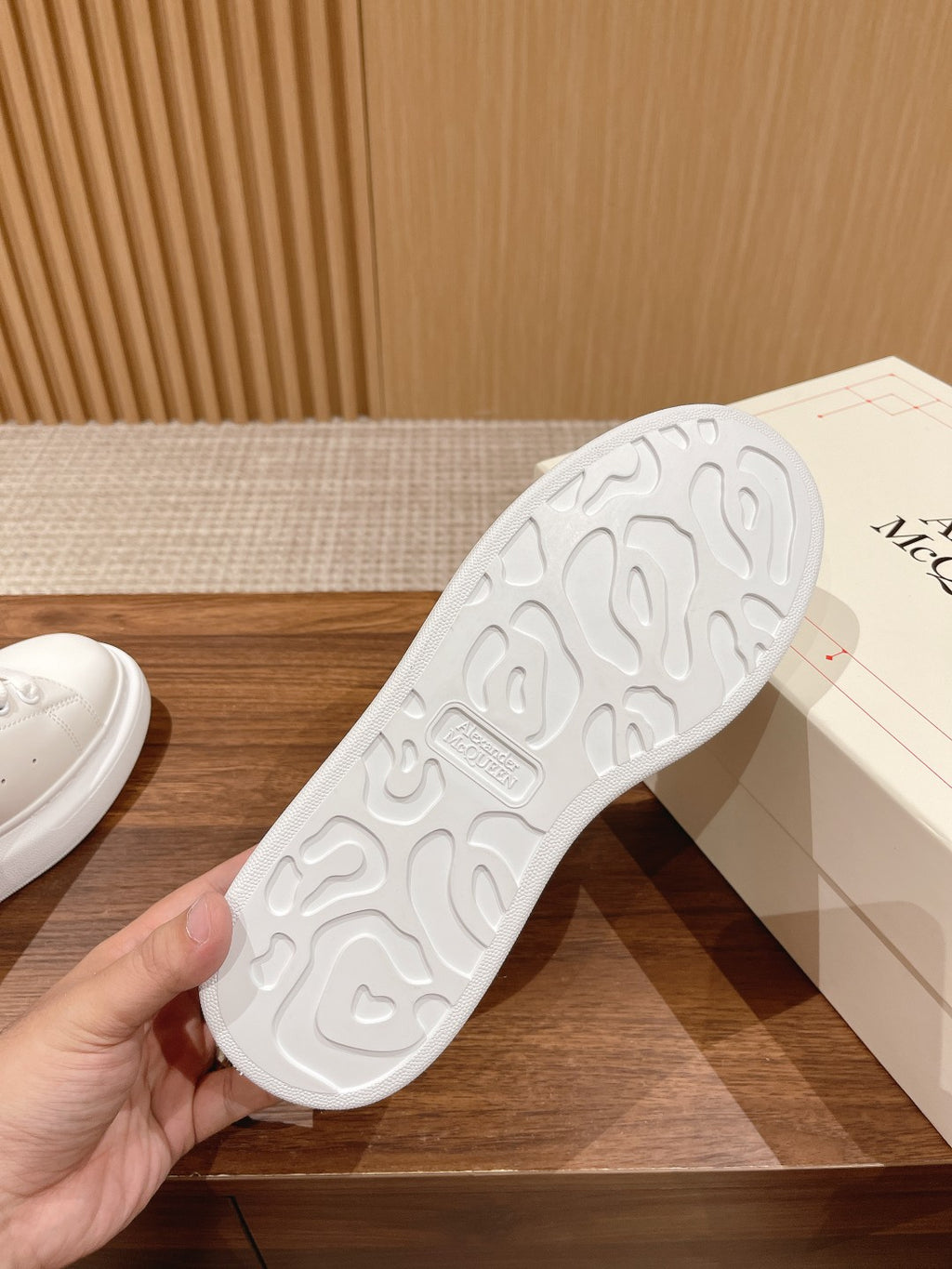Rubber outsole of white sneakers with tread pattern, side up