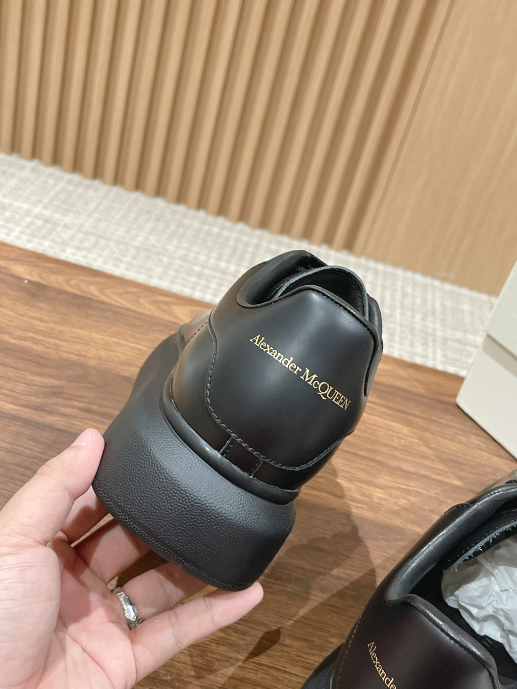 Black sneaker heel with Alexander McQUEEN logo patch and padded collar