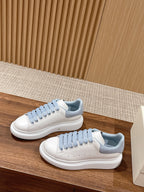 Alexander McQueen low-top sneakers, white leather with light blue laces and toe perforations