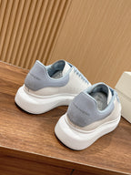 Alexander McQueen sneakers, back view of white leather with light blue heel tab