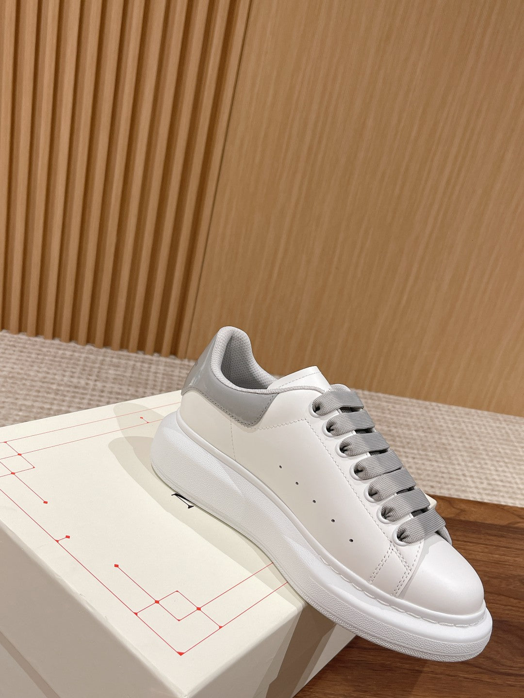 White and gray lace-up sneakers with smooth leather panels