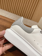 White sneakers with gray trim and padded collar, side view