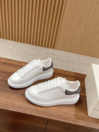 White leather lace-up sneakers with gray suede heel panel and side perforations