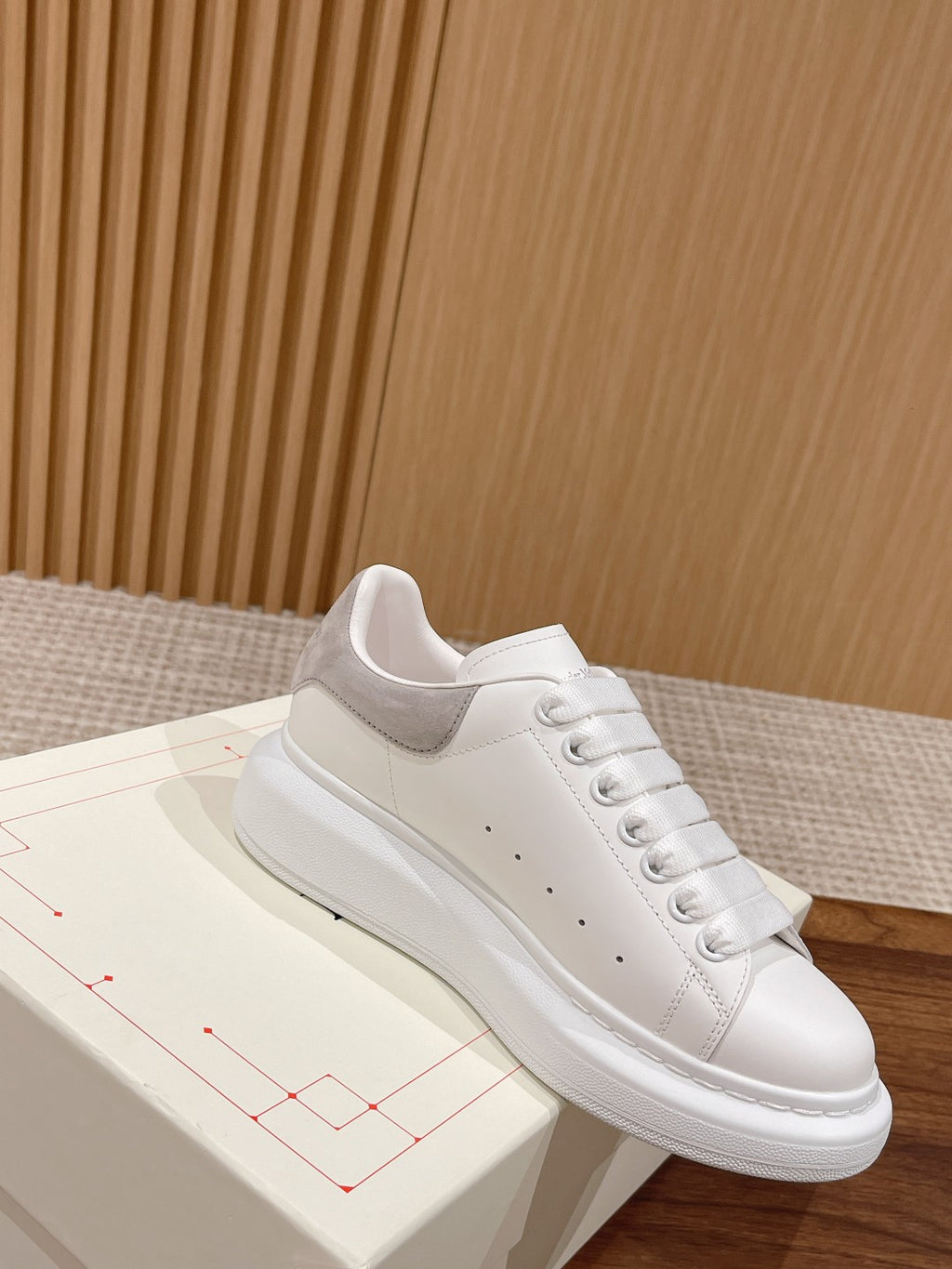 White leather lace-up sneaker with gray collar lining and cushioned sole