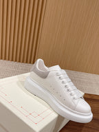 White leather lace-up sneaker with gray collar lining and cushioned sole
