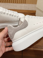 White and gray leather low-top sneakers with lace-up and chunky sole
