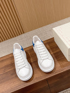 Pair of white leather low-top sneakers with blue collar, white laces