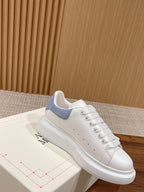 White leather lace-up sneaker with light blue collar panel and stitched toe