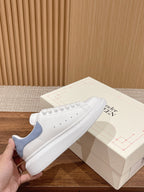 White leather lace-up sneaker with light blue suede heel patch and perforated toe