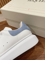 White leather sneaker with light blue suede collar panel and side stitching
