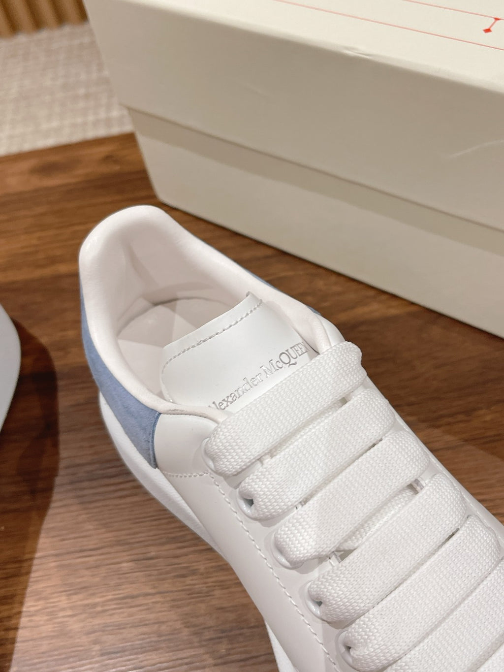 White leather sneaker with light blue suede heel panel and Alexander McQueen interior logo