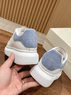 White leather sneaker with light blue suede heel and cushioned rubber heel cap