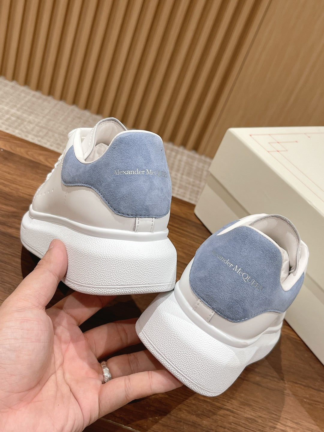 White leather sneaker with light blue suede heel and cushioned rubber heel cap