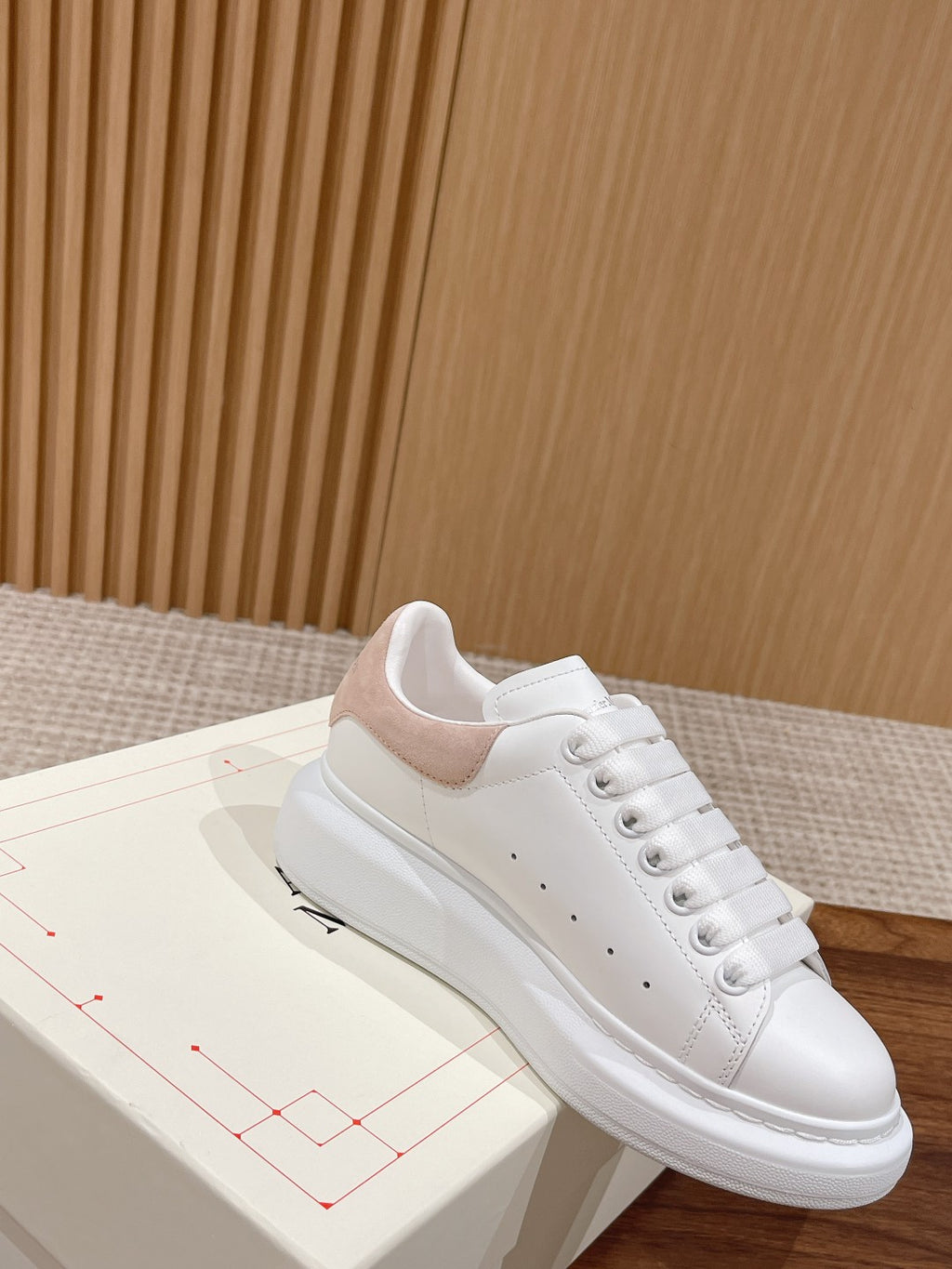 White leather sneakers with tan suede heel and lace-up front