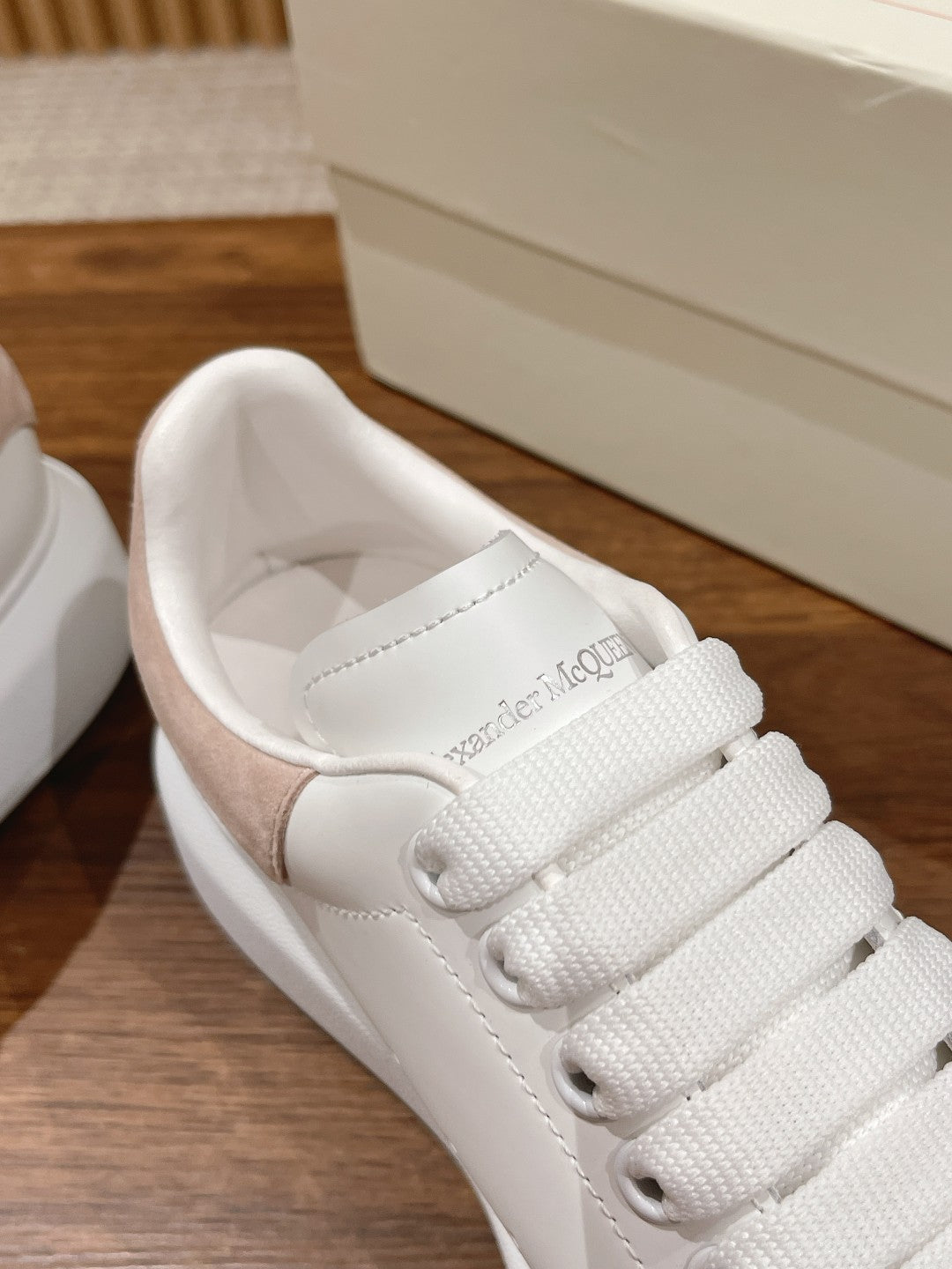 White sneaker with lace-up closure and stitched collar with cushioned lining