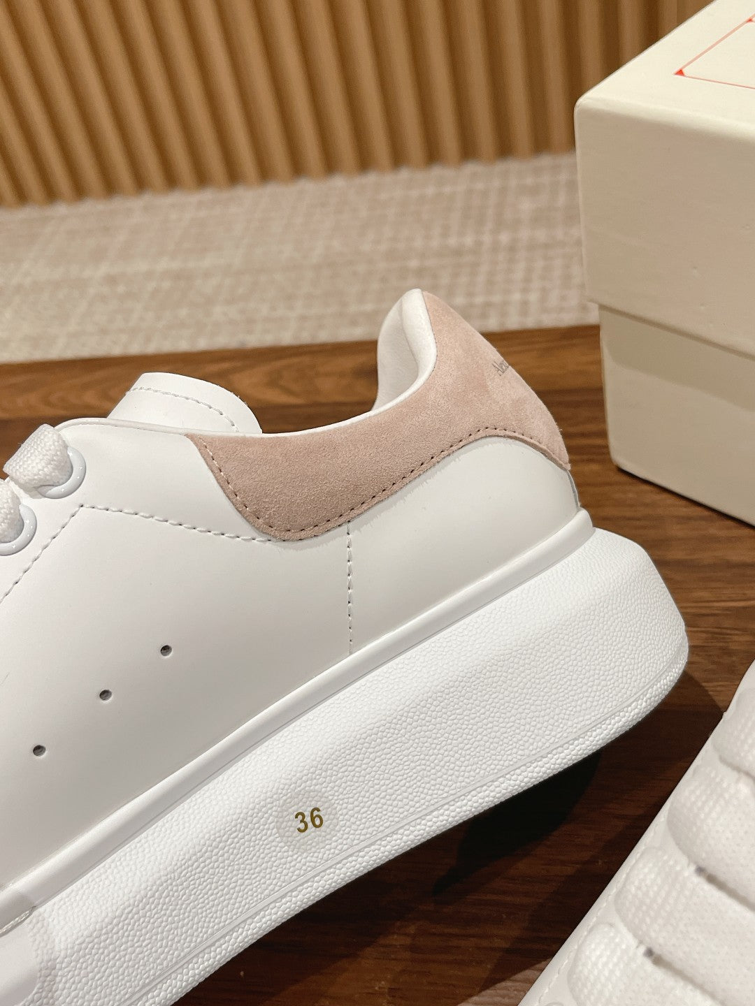White leather low-top sneaker with tan suede side panel and lace-up upper